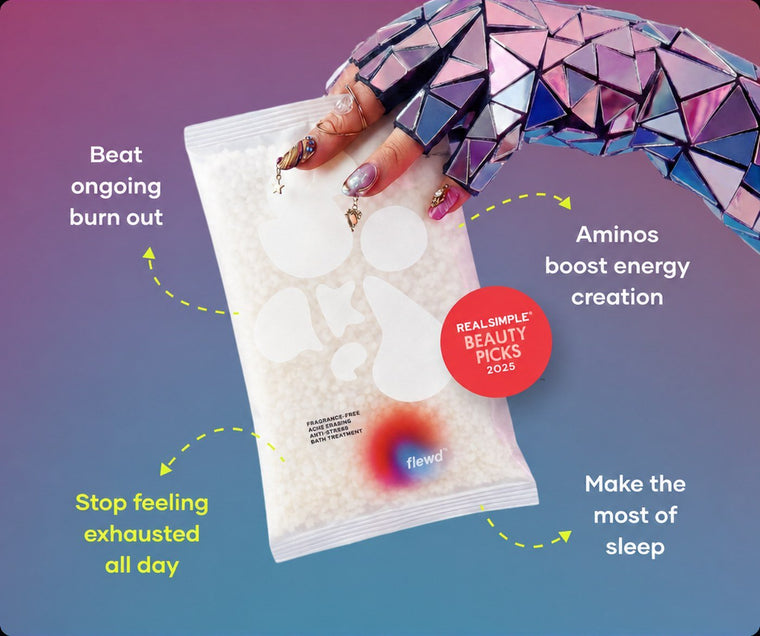 Flewd fragrance-free Ache Erasing bath soak clear pouch held by a mirrored glove, for achy days