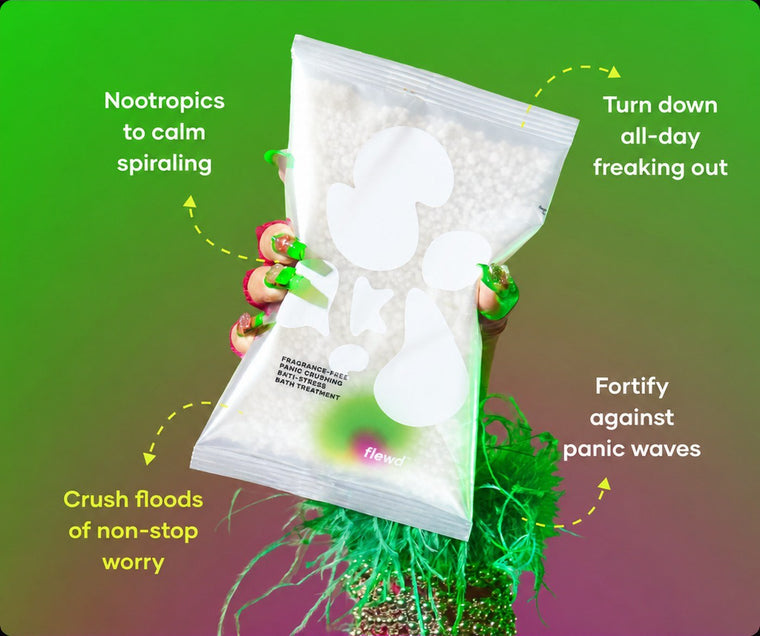 Flewd fragrance-free Panic Crushing bath soak clear pouch held in a green-painted hand, for overwhelmed moments