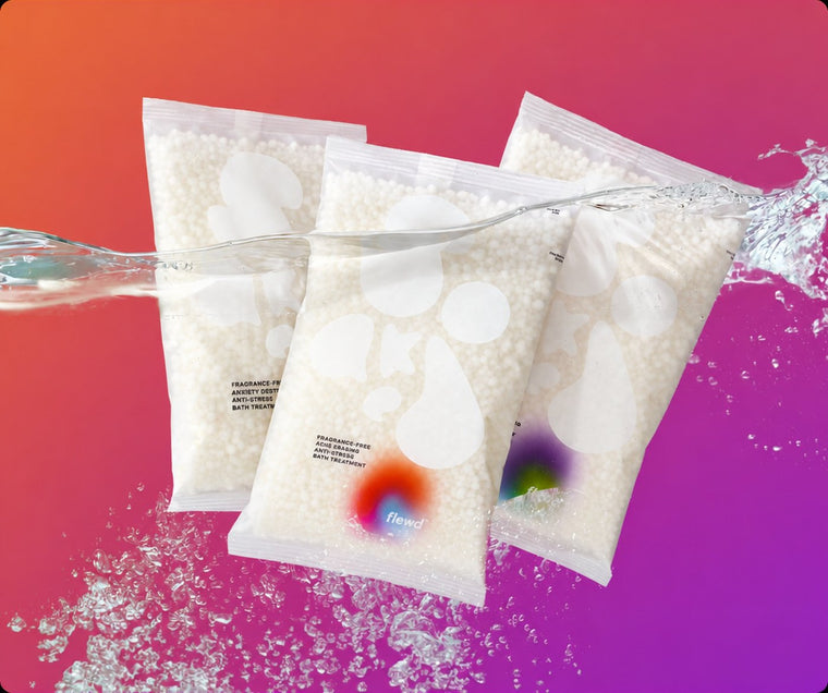 Three fragrance-free Stresscare Trio magnesium bath soak pouches with a water splash