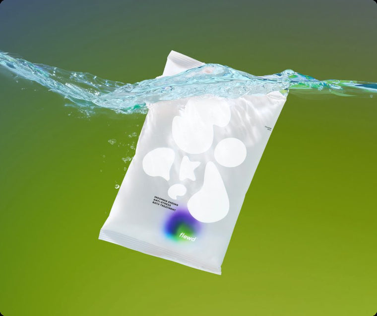 Flewd Insomnia Ending magnesium bath soak pouch splashing into water on a green background