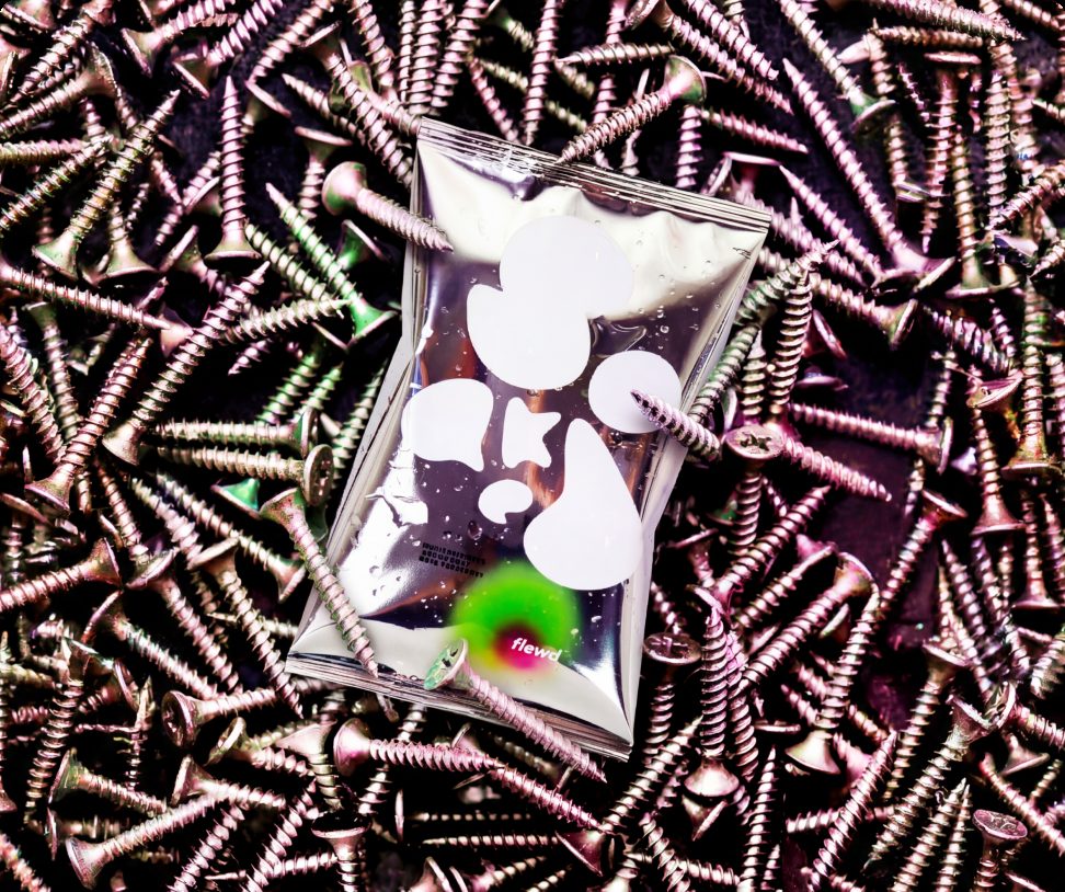 Flewd Panic Crushing stresscare bath soak pouch on a pile of metal screws